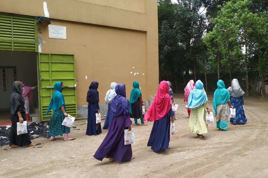 A group of women walking together next to a building